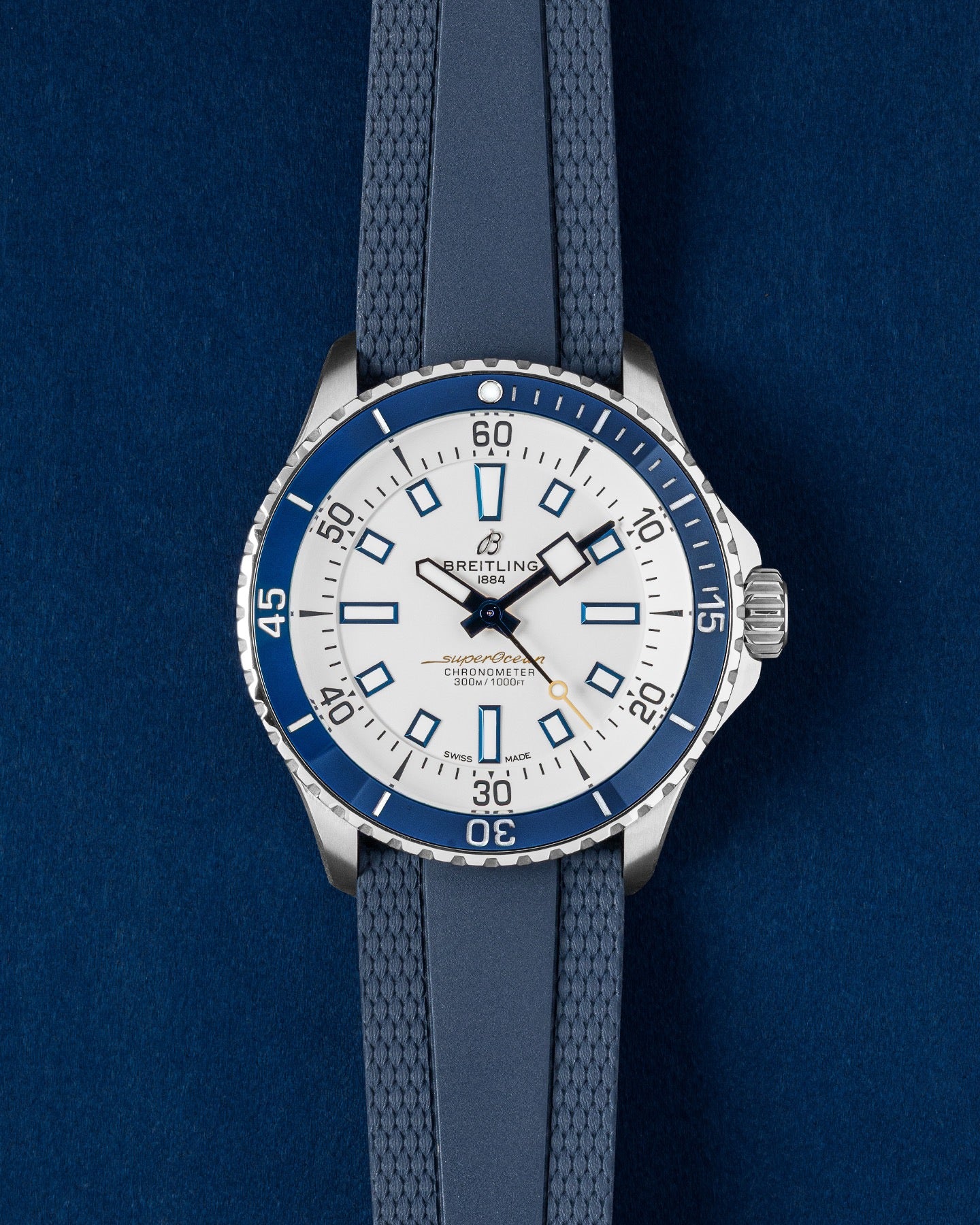 Breitling Superocean Automatic 42 watch featuring a white dial, contrasting dark blue ceramic bezel and a blue textured rubber strap