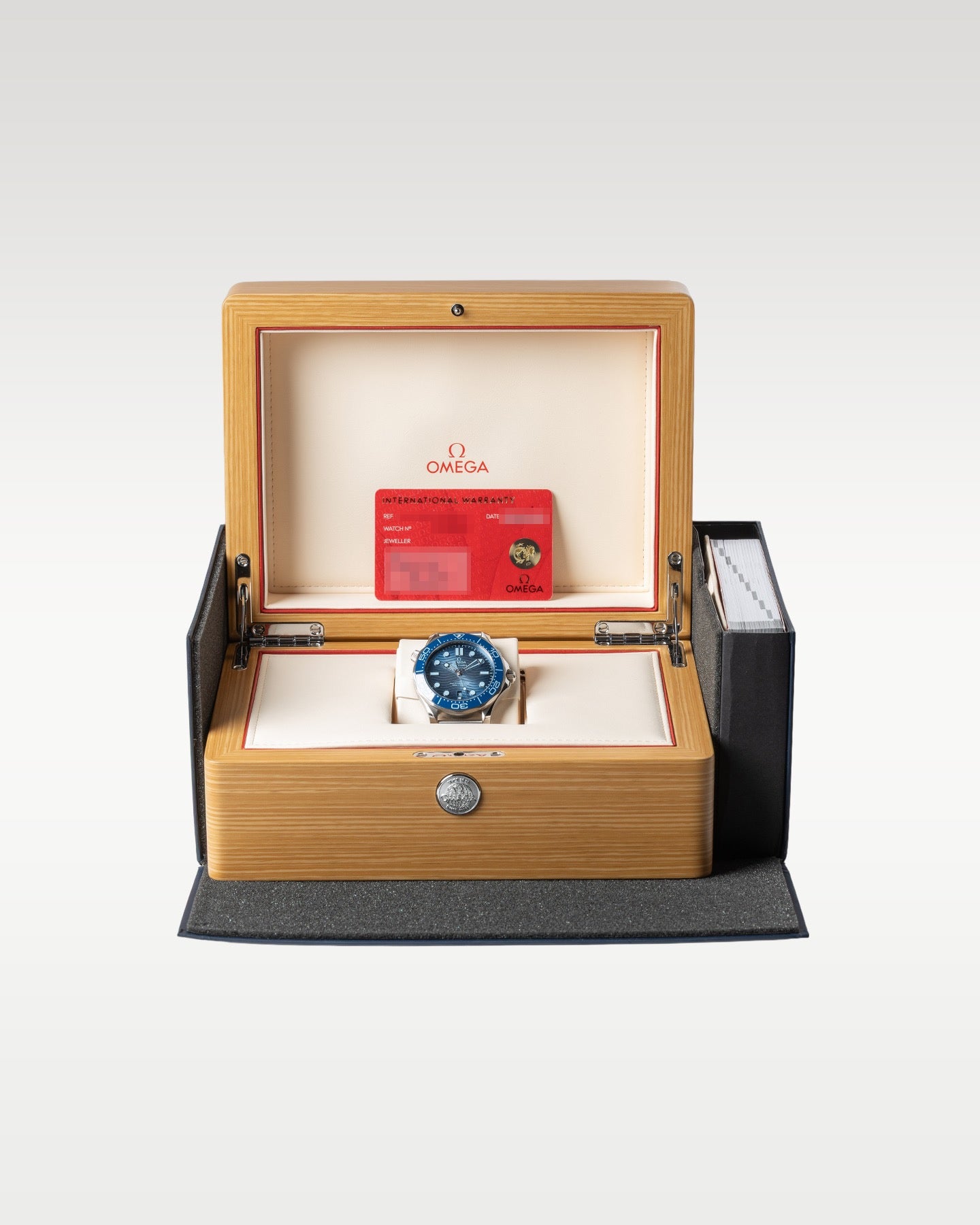 The complete retail collector package featuring the pre-owned Summer Blue diver watch nestled inside its official light wood presentation chest with its red guarantee card
