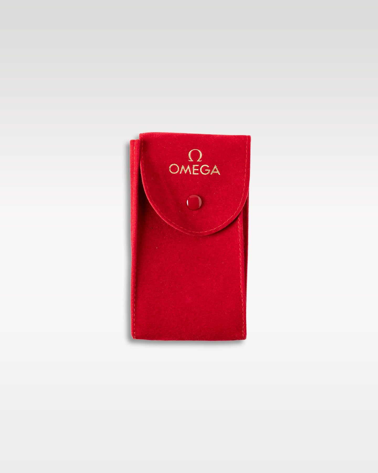 An official premium red textured leather travel watch pouch with a button-snap closure from the Omega packaging kit