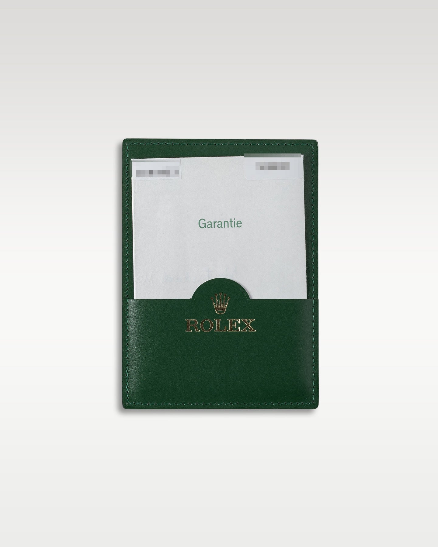 Original punch-paper international guarantee certificate in its green leather wallet for a 2007 Rolex Submariner
