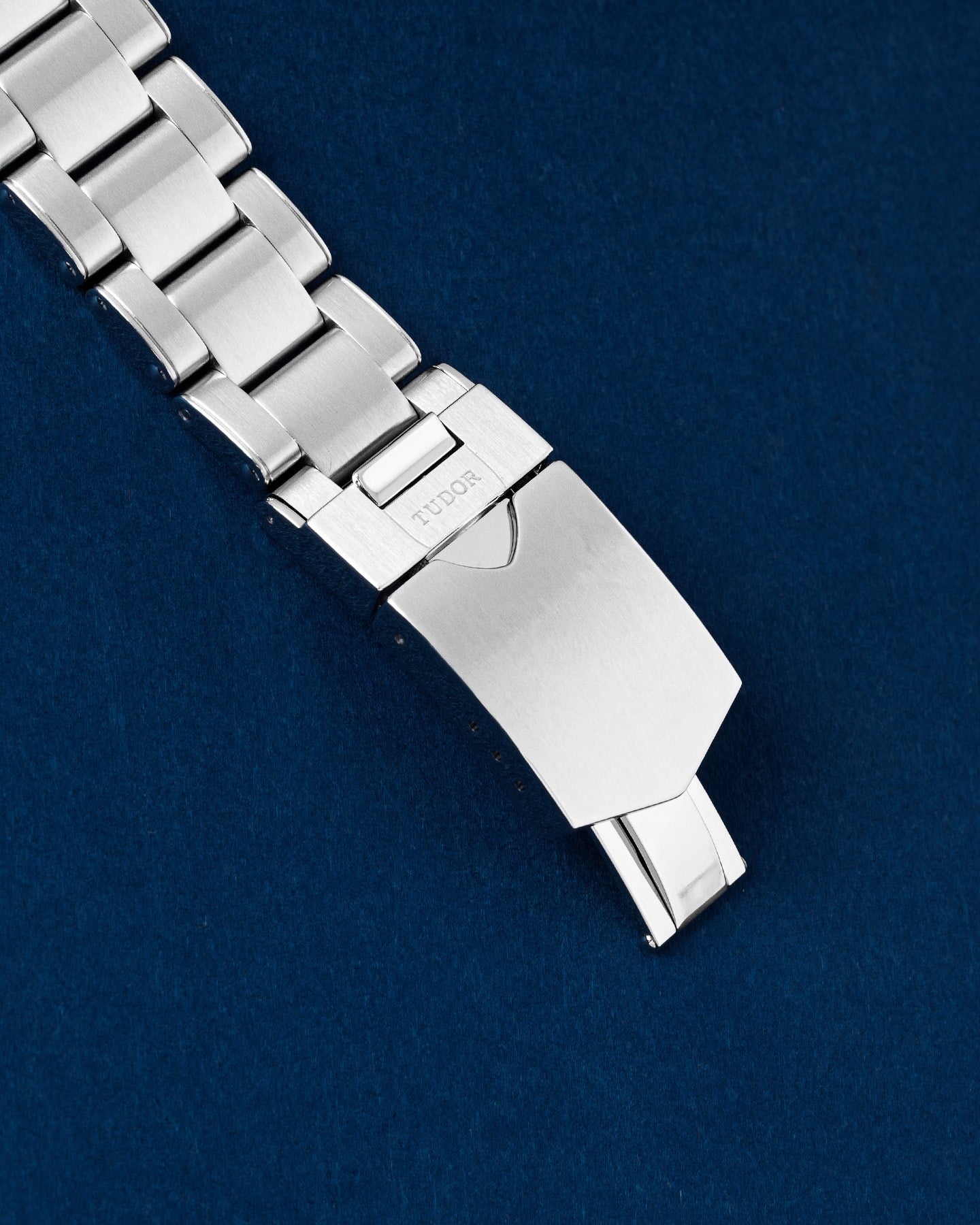 exterior folding stainless steel safety clasp on a Tudor rivet-style sport watch bracelet