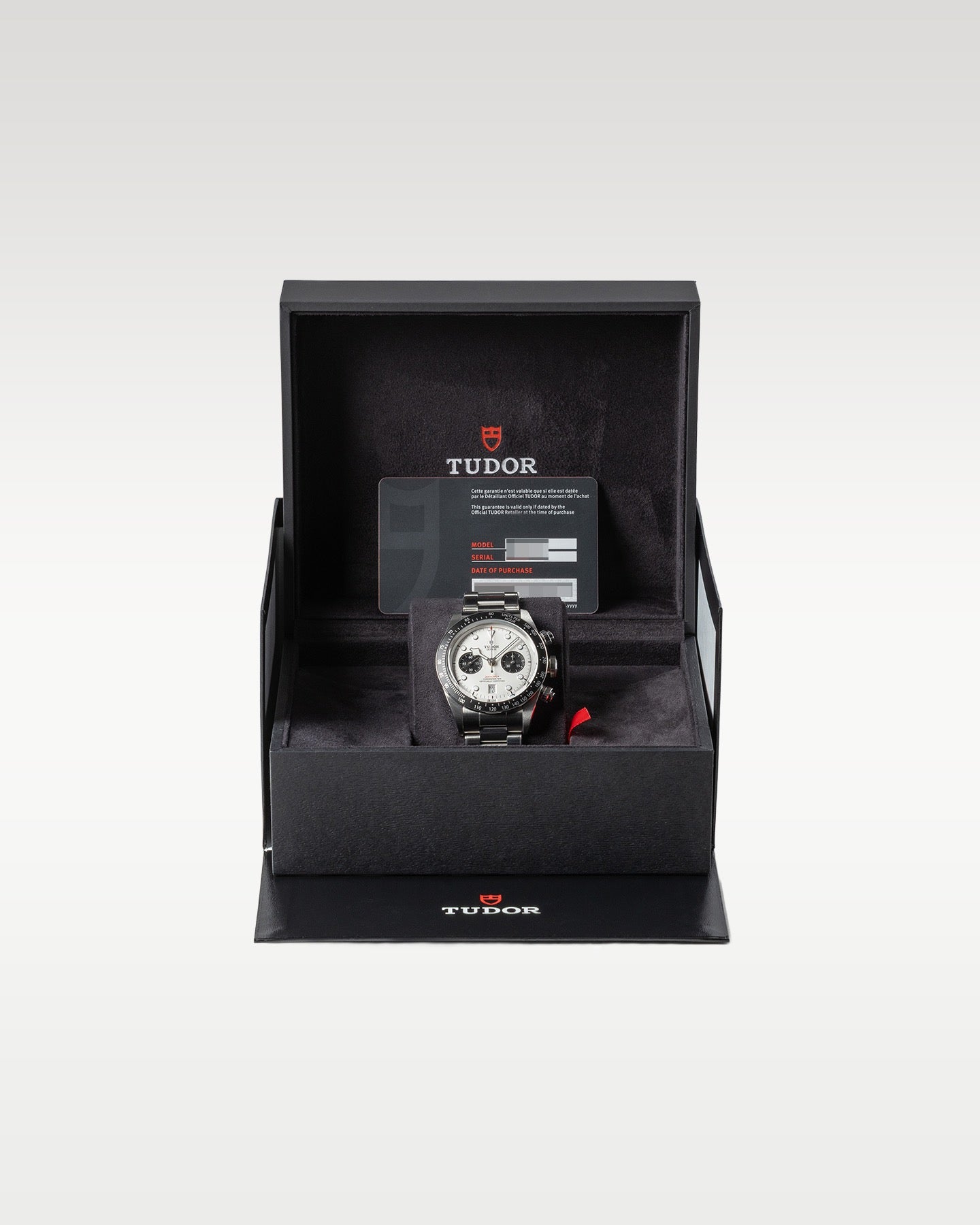 open black textured Tudor luxury watch presentation box displaying a steel Black Bay Chrono Panda watch inside