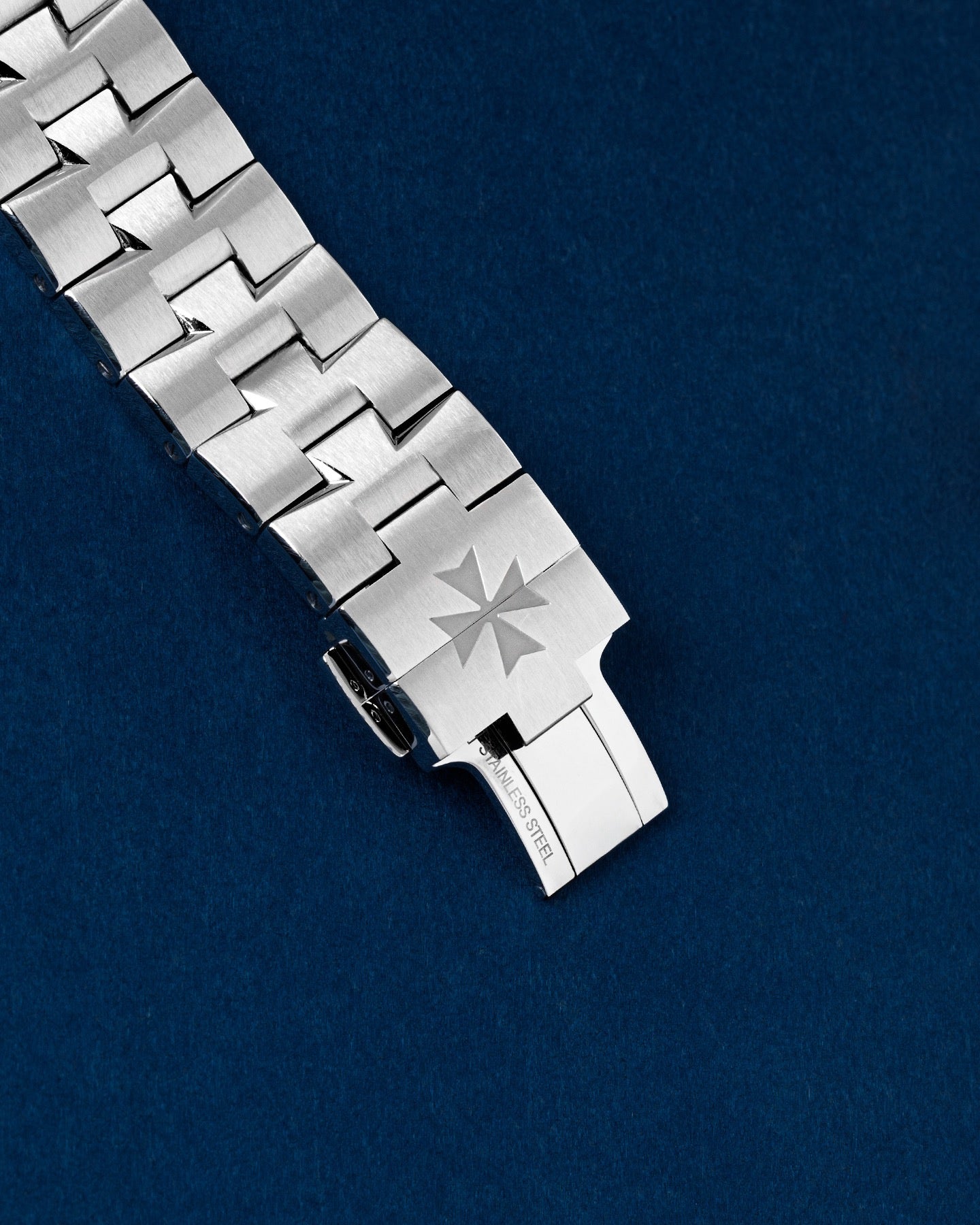 exterior view of a stainless steel Overseas bracelet clasp cleanly forming a Maltese Cross emblem when closed
