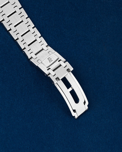 exterior view of an integrated stainless steel Audemars Piguet Royal Oak link bracelet showing the engraved AP folding buckle clasp