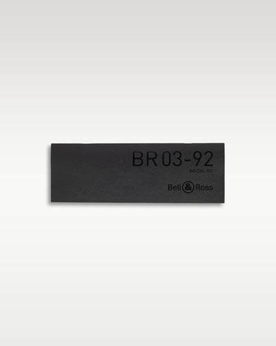 A dark military green rubberized accessory identification badge debossed with the official Bell and Ross BR03-92 MA-1 model designation lettering