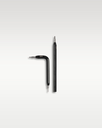 A pair of specialized matte black metal hex screwdrivers included for removing case pins and swapping straps on a square Bell and Ross watch