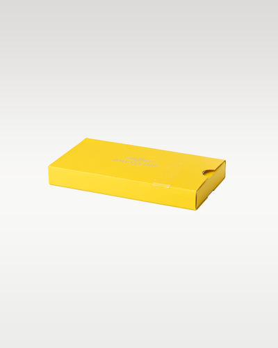 A closed rectangular signature yellow cardboard slide sleeve box used to protect the inner Breitling leather watch holder