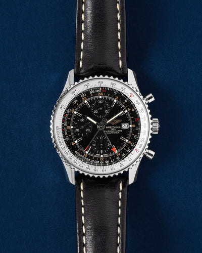 Breitling Navitimer World A2432212/B726, black dial with slide rule bezel and GMT hand, brown leather strap, front view