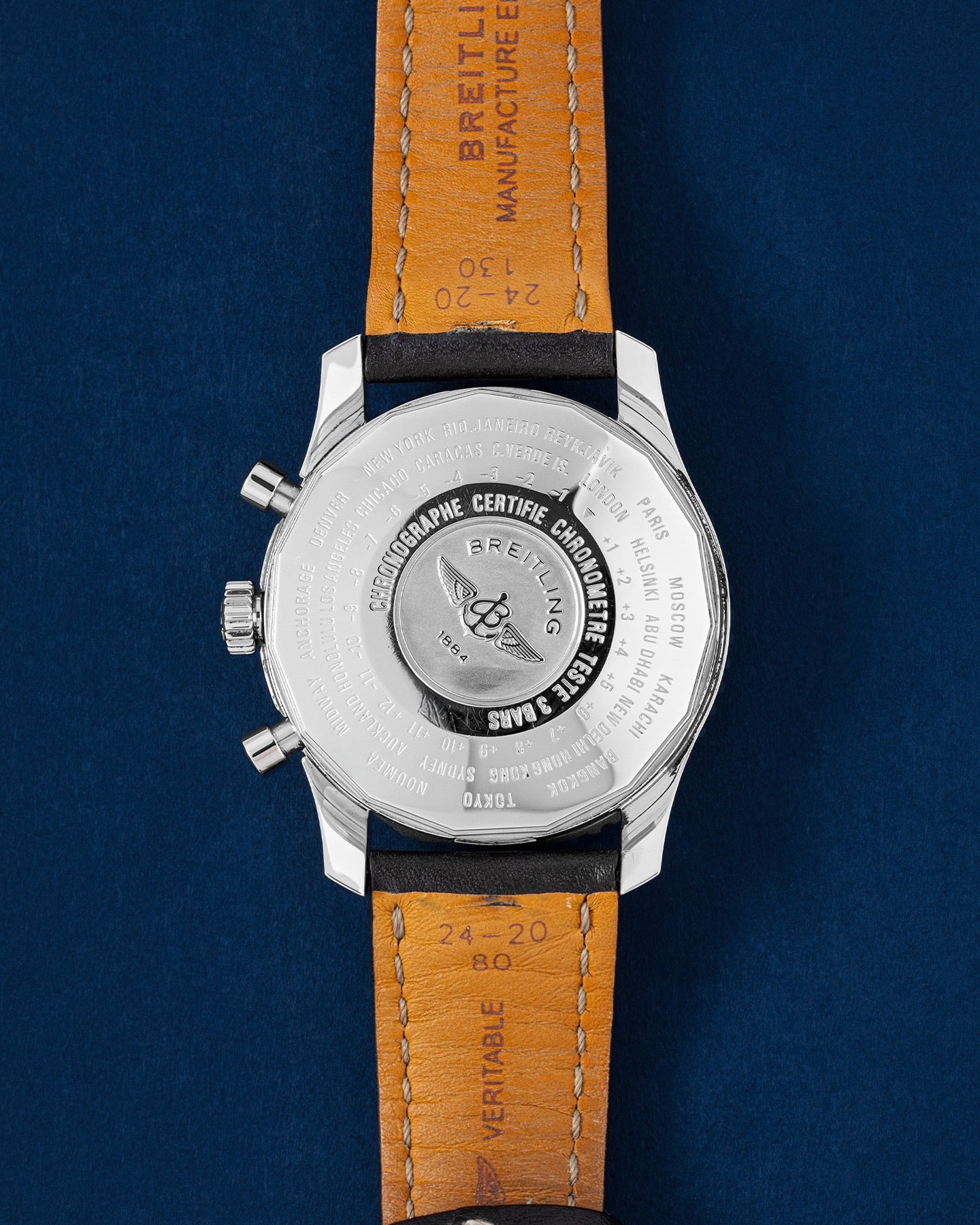 Breitling Navitimer World A2432212/B726, worn on brown leather strap, angled wrist view