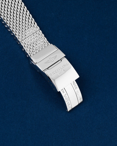 Close-up view of the closed stainless steel folding deployment clasp with safety lever stamped with the vintage style Breitling logo