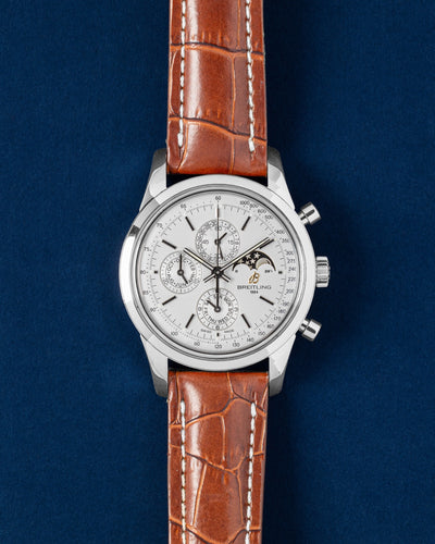 A preowned Breitling Transocean Chronograph 1461 reference A1931012 showing its mercury silver leap-year calendar dial and integrated moon phase subdial at Grand Caliber in Dallas