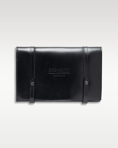 A premium heavy black leather travel watch roll pouch with buckled straps from the Bremont packaging suite