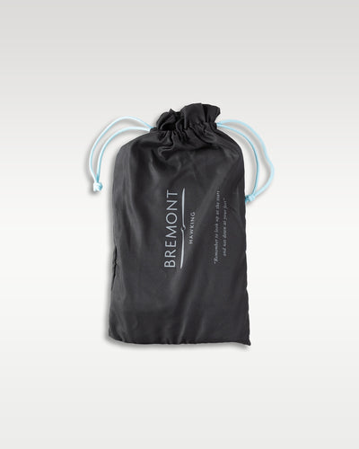 A black microfiber drawstring storage bag with white stitched Bremont London branding