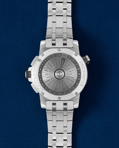 The reverse view of the heavy-duty stainless steel watch head highlighting the solid screw-down caseback etched with a global time zone calculation scale wheel graphic