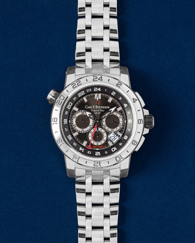 A pre-owned Carl F. Bucherer Patravi TravelTec GMT reference 00.10633.08.33.21 displaying its dark chronograph dial and three time zone selection hands at Grand Caliber in Dallas