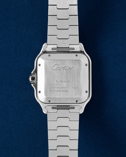 The reverse orientation of the square stainless steel watch head highlighting the satin-brushed solid caseback with official Cartier brand signatures and individual serial number engravings