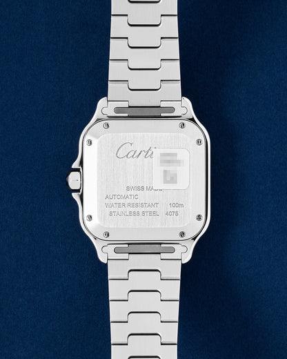 Close-up view of the engraved stainless steel caseback on a 2026 pre-owned Cartier Santos