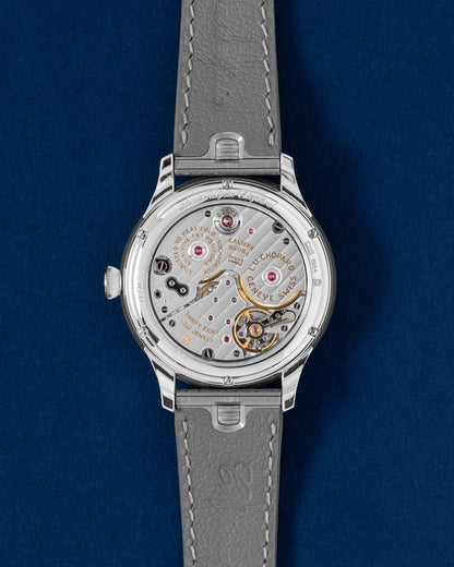 Sapphire exhibition caseback displaying the manual-wind L.U.C Calibre 98.01-L 9-day power reserve movement with Poinçon de Genève seal