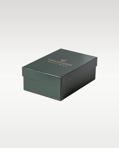 closed rectangular dark forest green protective outer cardboard box with the Chronoswiss gold brand logo
