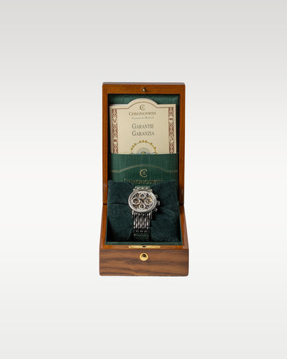 Open varnished luxury wooden Chronoswiss watch box displaying a green velvet interior and paper holder slot