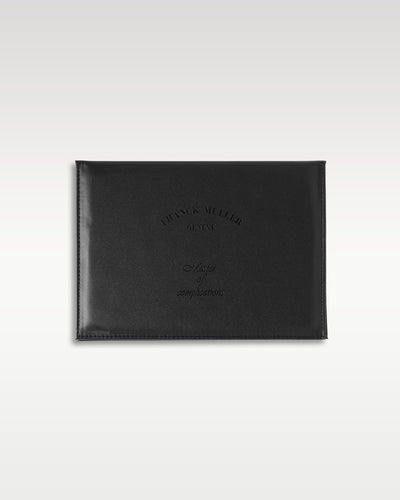 A top down view of the horizontal official black textured leather portfolio wallet used to securely package the brand's international certificate of origin and guarantee registry