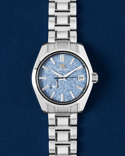 A preowned 2024 Grand Seiko Heritage SBGA507 showcasing its pale ice-blue Kirazuri sparkling mica dial texture and smooth gliding sweep hand at Grand Caliber in Dallas