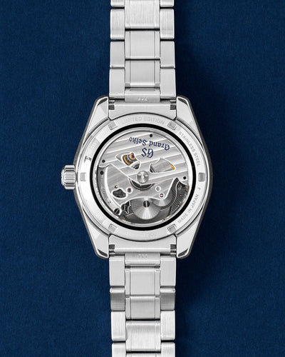 Rear exhibition view through a sapphire crystal revealing the hybrid mechanical quartz Spring Drive caliber 9R65 movement and its circular decorative rotor