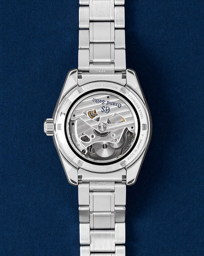 Rear exhibition view through a sapphire crystal revealing the hybrid mechanical quartz Spring Drive caliber 9R65 movement and its circular decorative rotor