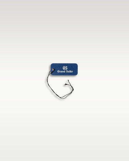 A secondary blue branded retail string component used to secure original factory tags to the metal bracelet links