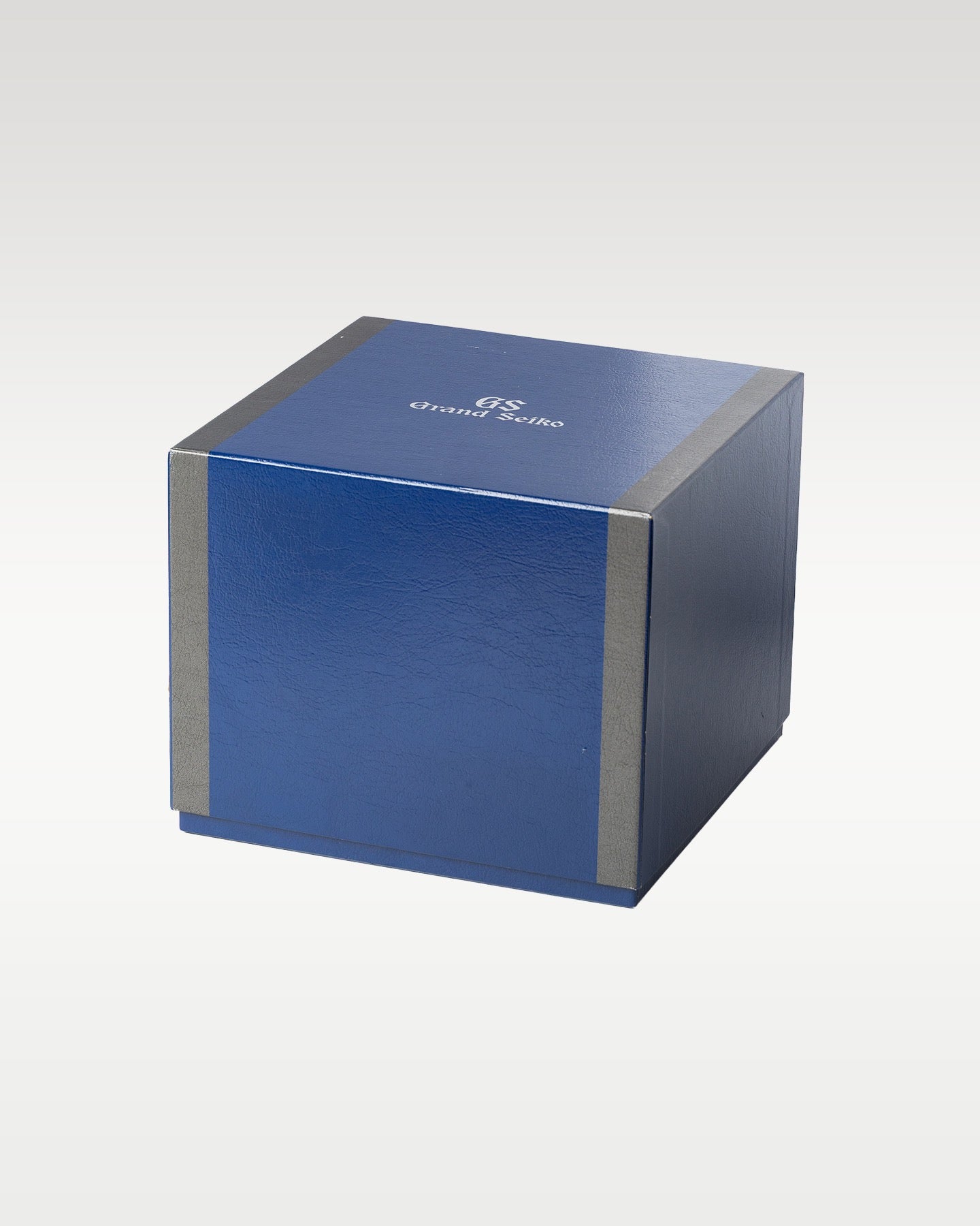 dark navy blue matte rectangular Grand Seiko outer protective cardboard watch box sleeve with silver trim lines