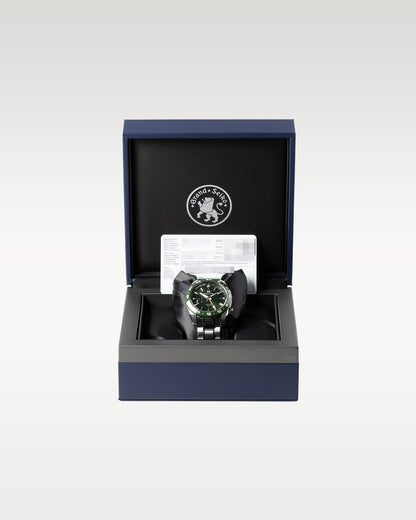open luxury Grand Seiko inner presentation box lined with black plush fabric with a green SBGE257 watch