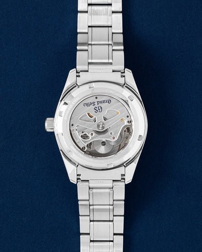The sapphire crystal exhibition caseback of a Grand Seiko SBGE211 showing the high-precision 9R66 Spring Drive automatic movement