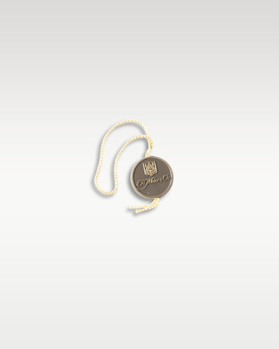 Official round cream-colored H. Moser & Cie. collector's brand hang tag with cord