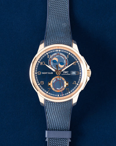 2021 IWC Portugieser Yacht Club Moon & Tide IW344001 18k red gold watch with a nautical blue complication dial on a dark blue background