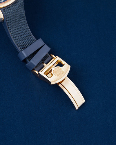 Close-up of the premium blue rubber strap highlighting the solid 18k 5N red gold folding deployment clasp closure
