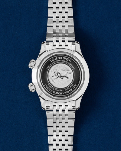 Solid stainless steel screw-down caseback featuring the embossed vintage scuba diver relief motif on a Longines Legend Diver 39