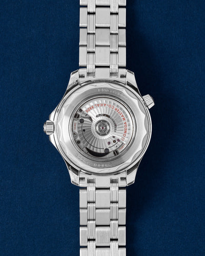 Rear exhibition profile through a sapphire crystal revealing the self-winding Omega caliber 8800 movement with rhodium-plated finishes and Geneva waves in arabesque