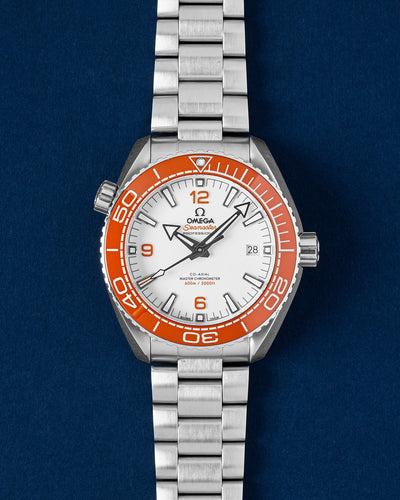 Pre owned 2021 Omega Seamaster Planet Ocean 600M 43.5mm white dial watch with orange ceramic bezel on steel bracelet at Grand Caliber Dallas