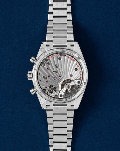 Sapphire crystal caseback view showcasing the manual-winding Omega Co-Axial Master Chronometer Calibre 9906 chronograph movement