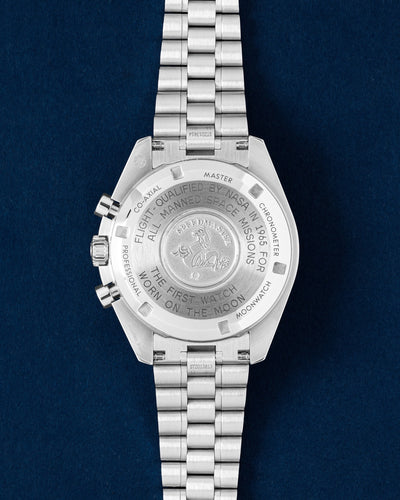 The solid stainless steel caseback of an Omega Speedmaster Moonwatch showing the official NASA flight-qualified engravings and Seahorse emblem
