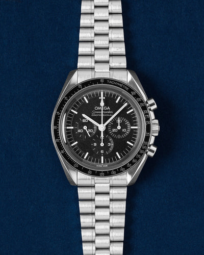 2023 Omega Speedmaster Moonwatch Professional 42mm 310.30.42.50.01.001 Hesalite watch on a deep blue studio background