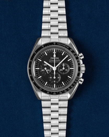 2023 Omega Speedmaster Moonwatch Professional 42mm 310.30.42.50.01.001 Hesalite watch on a deep blue studio background