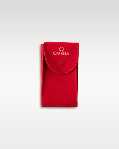 An official premium red textured leather travel watch pouch with a button-snap closure from the Omega packaging kit