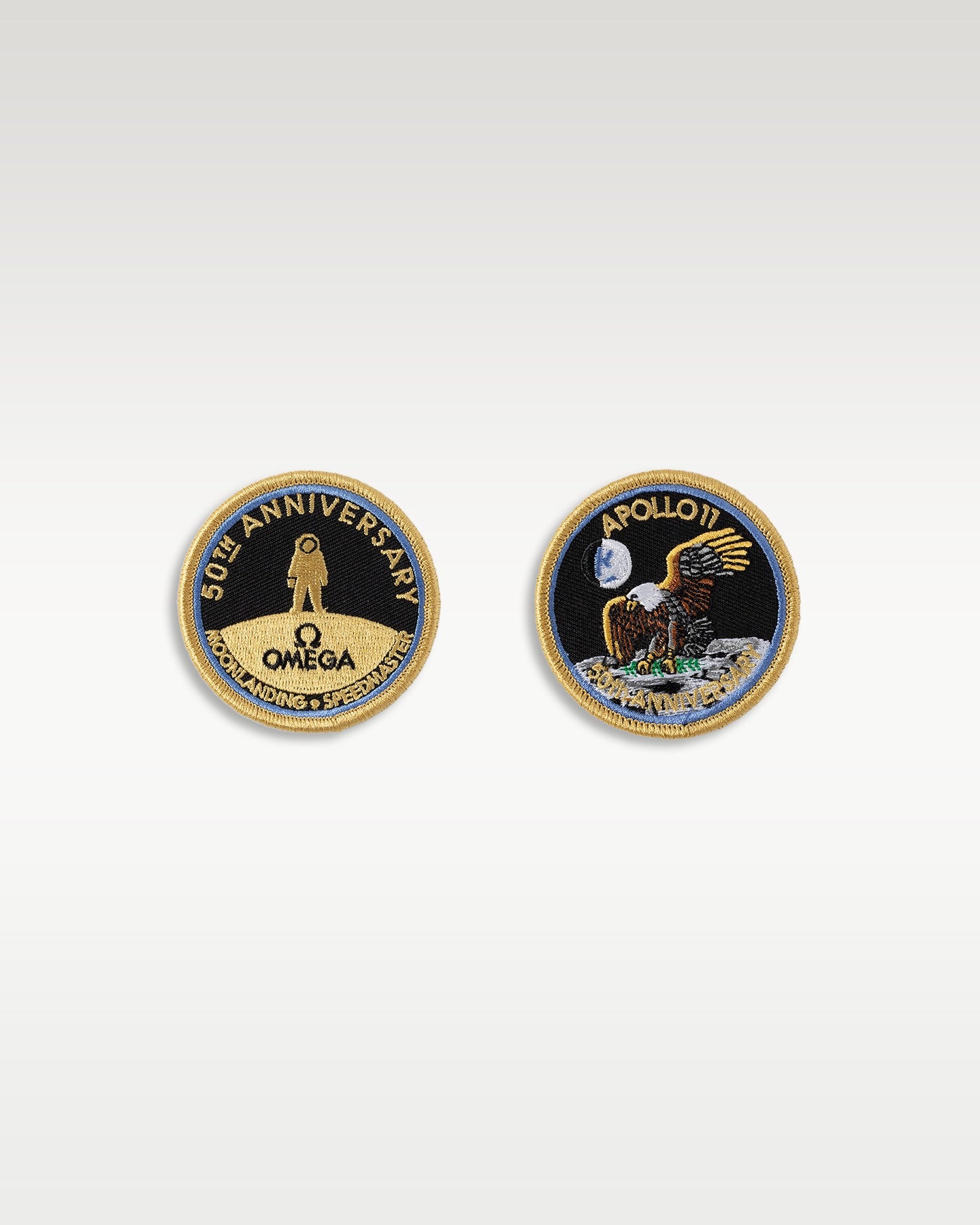 Pair of official Omega Speedmaster Apollo 11 50th Anniversary mission patch display coins side by side