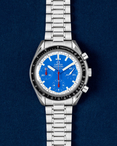 Pre owned Omega Speedmaster Reduced Michael Schumacher Racing 3510.80.00 blue dial automatic chronograph watch at Grand Caliber Dallas