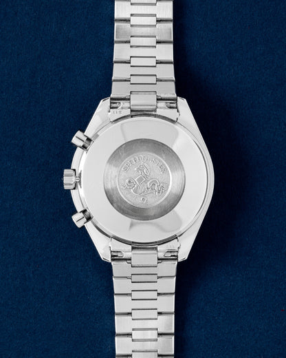 Solid stainless steel screw-in caseback featuring the traditional Omega hippocampus sea monster emblem on a Speedmaster Reduced