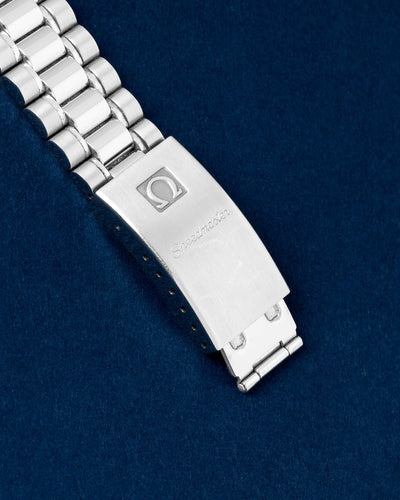 Close-up view of the closed stainless steel folding clasp stamped with the vintage Omega logo on a Speedmaster Reduced