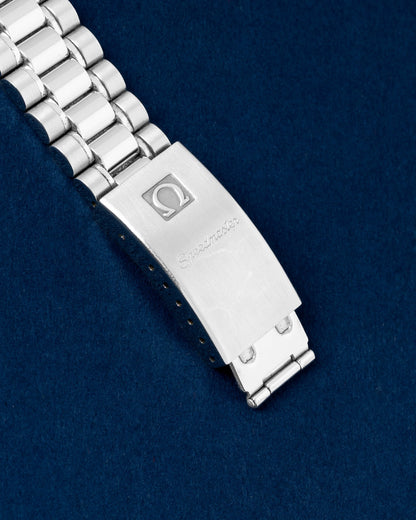 Close-up view of the closed stainless steel folding clasp stamped with the vintage Omega logo on a Speedmaster Reduced