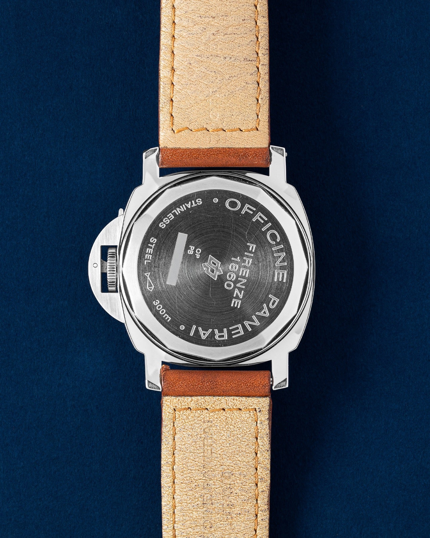 The reverse orientation of the stainless steel watch head highlighting the solid screw down caseback deeply engraved with factory markings for the Panerai Luminor Marina Logo PAM 00005 at Grand Caliber in Dallas, Texas