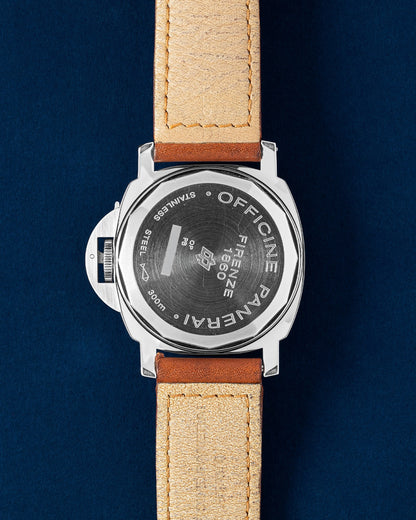 The reverse orientation of the stainless steel watch head highlighting the solid screw down caseback deeply engraved with factory markings for the Panerai Luminor Marina Logo PAM 00005 at Grand Caliber in Dallas, Texas